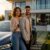 Ein Paar freut sich über sein neues E-Auto im Leasing vor ihrem Zuhause.